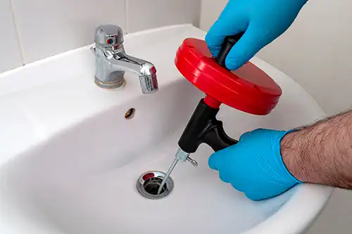 plumber cleans drains